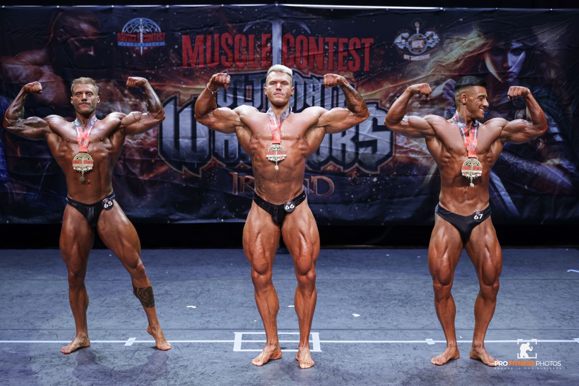 Bodybuilding medallists hitting front double biceps poses at Muscle Contest Ireland